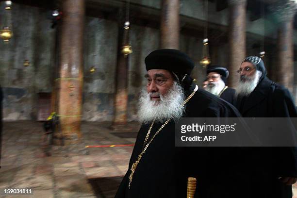 Archbishop Anba Abraham the Coptic Orthodox Metropolitan Archbishop of Jerusalem and clergy walk through the central nave of the Church of the...