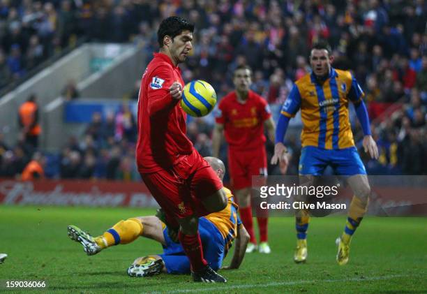 Luis Suarez of Liverpool appears to control the ball with his hand during the FA Cup with Budweiser Third Round match between Mansfield Town and...