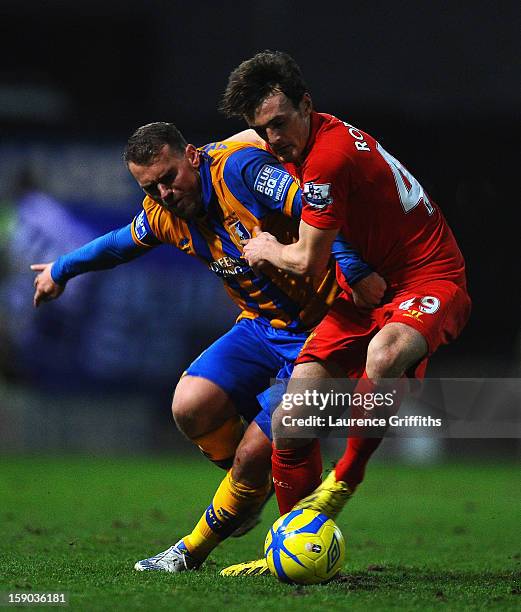 Louis Briscoe of Mansfield Town battles with Jack Robinson of Liverpool in action during the FA Cup with Budweiser Third Round match between...