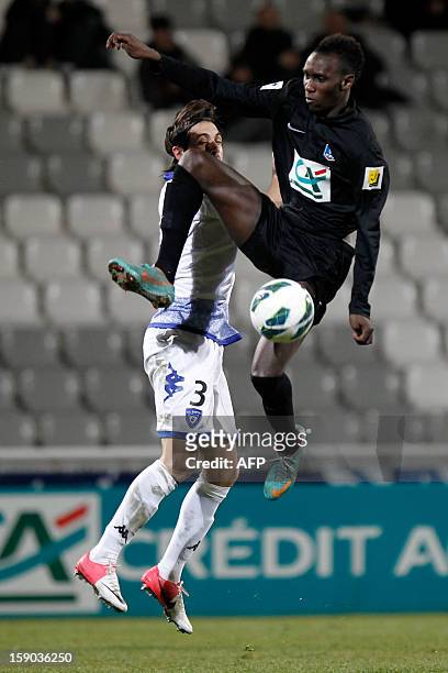 S forward Alassane N'Diaye vies with Bastia's Algerian defender Fethi Harek during a French Football Cup match CA Bastia vs Sporting Club de Bastia...