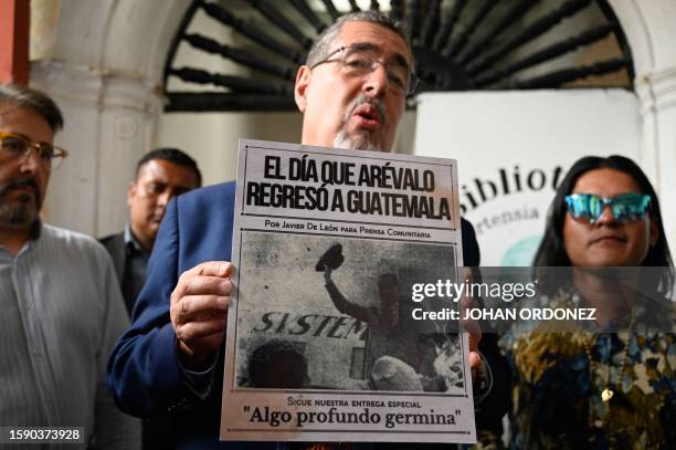 Guatemalan presidential candidate for the Semilla party, Bernardo Arevalo, shows a poster depicting a picture of his father, late Guatemalan...