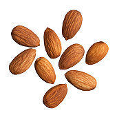 Nine scattered almonds on a white background