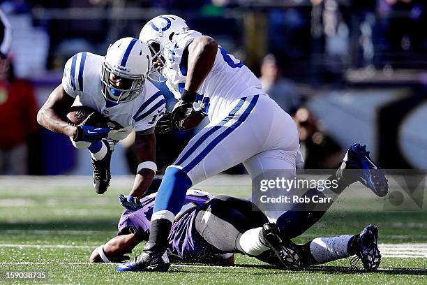 Hilton of the Indianapolis Colts is tripped up by Cary Williams of the Baltimore Ravens as Hilton ran for yards after the catch in the first half...