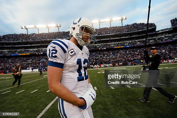 Andrew Luck of the Indianapolis Colts walks off of the field dejected after they lost to the Baltimore Ravens 24-9 during the AFC Wild Card Playoff...