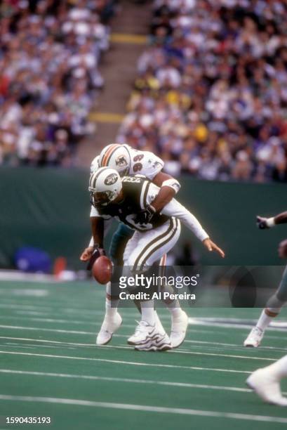 Defensive End Jason Taylor of the Miami Dolphins has a Sack and Forced Fumble of Quarterback Vinny Testaverde of the New York Jets in the game...