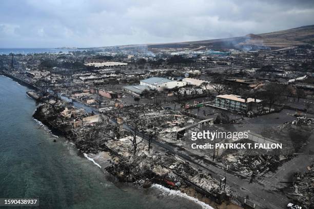 An aerial image taken on August 10, 2023 shows destroyed homes and buildings on the waterfront burned to the ground in Lahaina in the aftermath of...