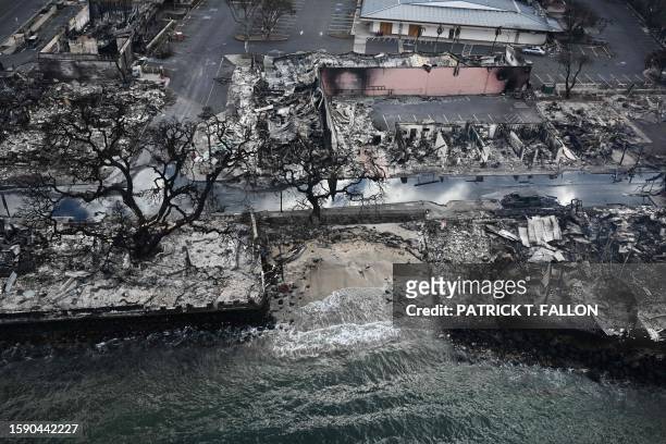 An aerial image taken on August 10, 2023 shows destroyed homes and buildings on the waterfront burned to the ground in Lahaina in the aftermath of...