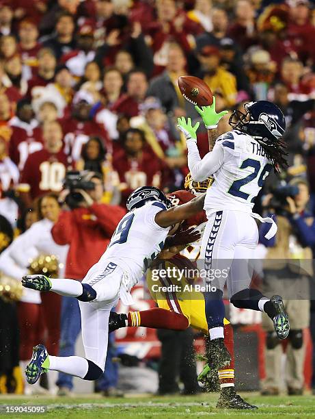 Earl Thomas of the Seattle Seahawks intercepts a pass intended for Pierre Garcon of the Washington Redskins in the second quarter during the NFC Wild...