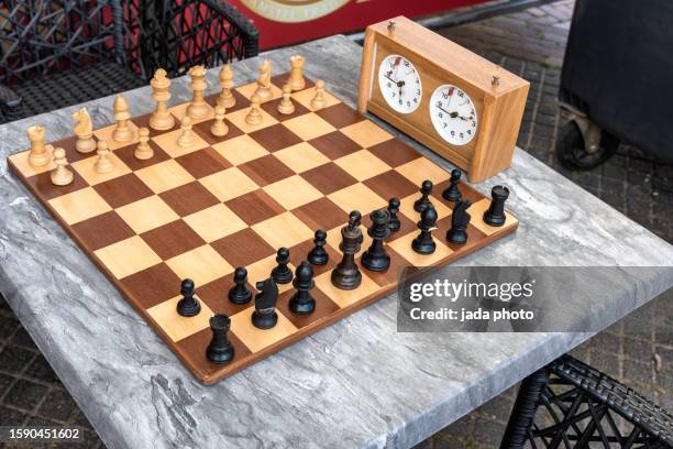 chessboard with chess pieces and a chess clock - chess timer stock pictures, royalty-free photos & images