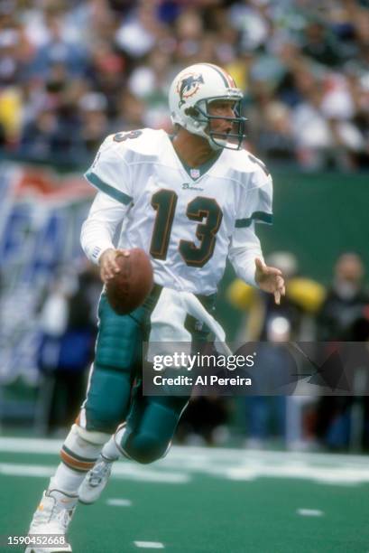 Quarterback Dan Marino of the Miami Dolphins rolls out to pass in the game between the Miami Dolphins vs the New York Jets at The Meadowlands on...