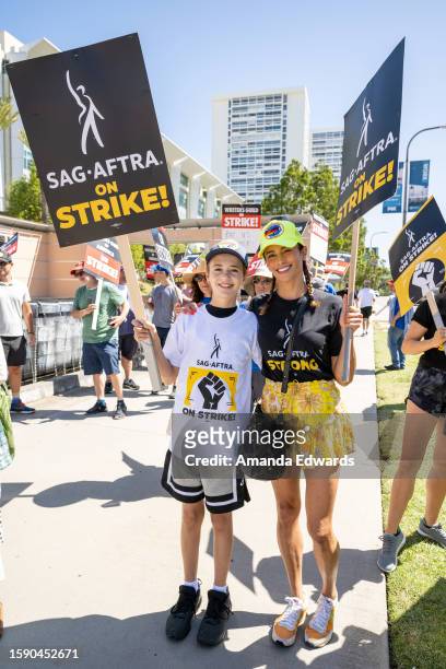 Actress Paula Patton and her son Julian Fuego Thicke join members and supporters of SAG-AFTRA and WGA on the picket line at Fox Studios on August 03,...