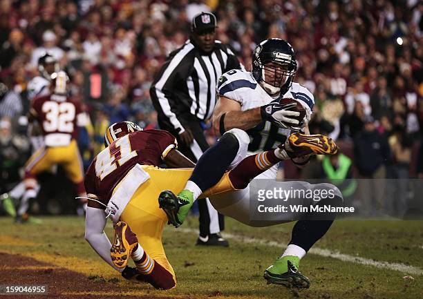 Zach Miller of the Seattle Seahawks scores on a two point conversion play against the defense of Madieu Williams of the Washington Redskins in the...