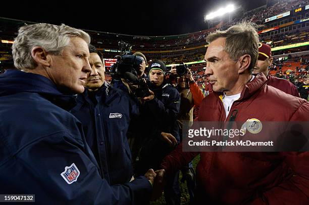 Head coach Pete Carroll of the Seattle Seahawks shakes hands with head coach Mike Shanahan of the Washington Redskins after the Seahawks defeated the...