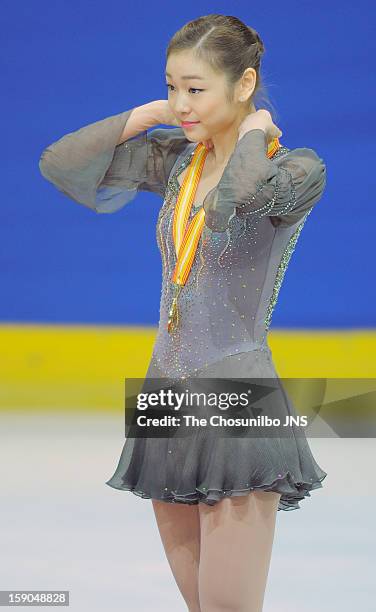 Kim Yu-Na poses for photographs at the medal ceremony after the competition during day three of Korea Figure Skating Championshpis 2013 at Mokdong...