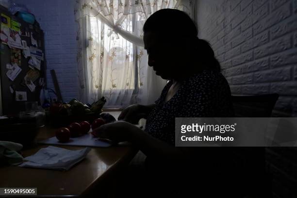 Melina Hernandez Valerio, originally from Tehuacan, Puebla, chops some ingredients for the preparation of Chiles en Nogada in Mexico City, on the eve...