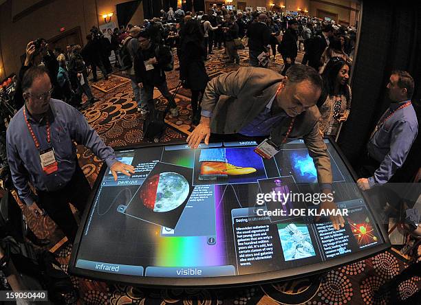 Diego Romeu of 3M Touch Systems shows 84 inch touch table during the opening event ''CES Unveiled'' during the International Consumer Electronics...