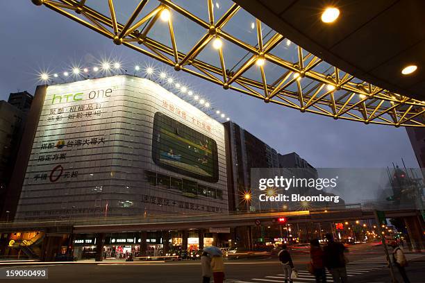 Traffic moves past a billboard advertisement for HTC Corp.'s One X+ smartphone in Taipei, Taiwan, on Sunday, Jan. 6, 2013. HTC is scheduled to...