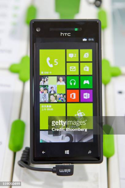 An HTC Corp. 8S smartphone is displayed at one of the company's stores in Taipei, Taiwan, on Sunday, Jan. 6, 2013. HTC is scheduled to release...