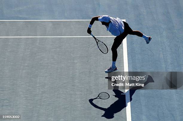 Julien Benneteau of France serves in his first round match against Pablo Andujar of Spain during day two of the Sydney International at Sydney...