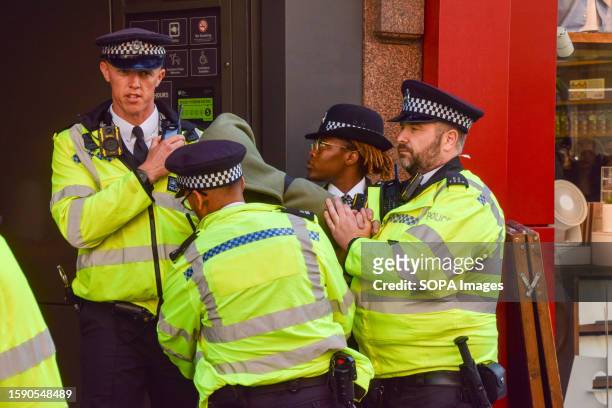 Police officers detain a young man on Oxford Street. A social media post reportedly organised a mass shoplifting event in the busy shopping street in...