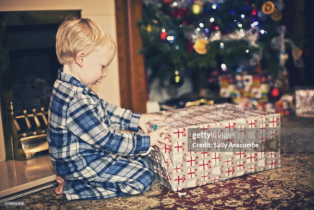 Child opening a present at Christmas.