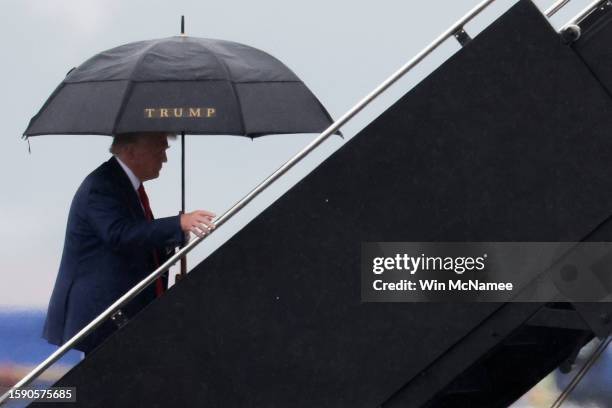 Former U.S. President Donald Trump boards his plane at Reagan National Airport following an arraignment in Washington, D.C. Federal court on August...