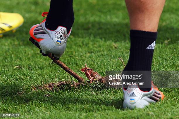 Anatoliy Tymoshchuk steps on a iron rod on the training pitch during a Bayern Muenchen training session at the ASPIRE Academy for Sports Excellence...