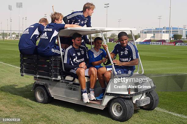 Jefferson Farfan , Edu and team mates leave the pitch on a golf cart after a Schalke 04 training session at the ASPIRE Academy for Sports Excellence...