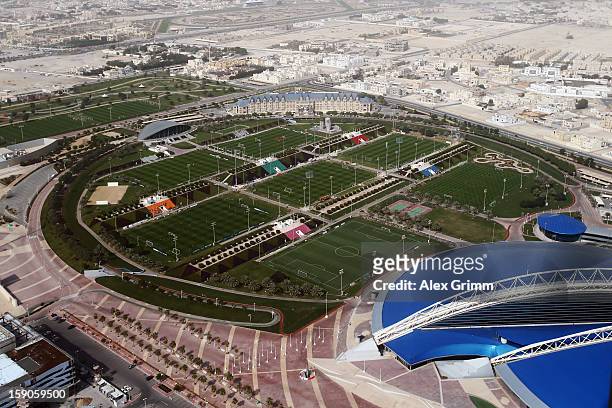 General view taken from the nearby 'The Torch Doha' hotel shows the teams of Bayern Muenchen and Schalke 04 during their training sessions at the...