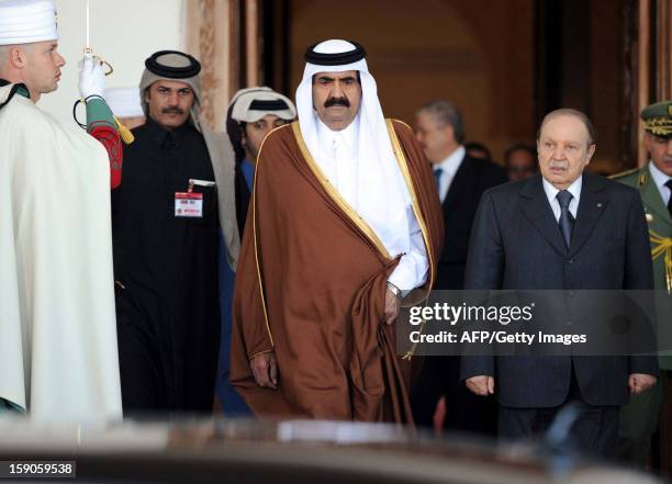 The Emir of Qatar, Sheikh Hamad bin Khalifa al-Thani and Algeria's President Abdelaziz Bouteflika leave the Boumediene airport on January 7, 2012 in...