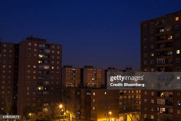Residential properties are seen illuminated by electric lights at night in Madrid, Spain, on Friday, Jan. 4, 2013. In December, the Spanish...