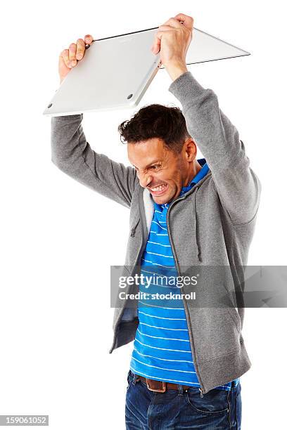 adult man frustrated with laptop. - man-throwing-laptop stock pictures, royalty-free photos & images