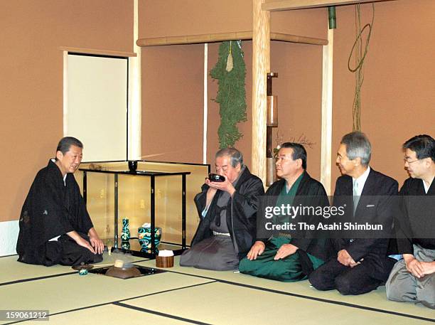 An guest is served a bowl of tea by Urasenke grand tea master Sen Soshitsu XVI during Hatugama-Shiki, the first tea ceremony of new year at Urasenke...