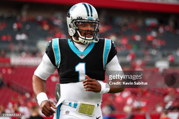 Cam Newton of the Carolina Panthers warms up prior to an NFL game against the Tampa Bay Buccaneers at Raymond James Stadium on January 9, 2022 in...