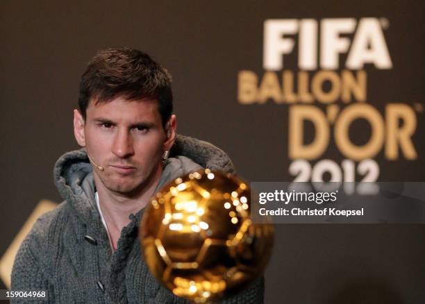 Lionel Messi of Barcelona watches Ballon d'Or trophy during the Press Conference with nominees for World Player of the Year and World Coach of the...