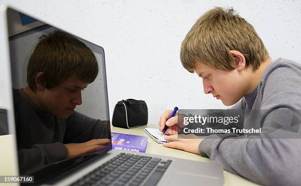 Pupil working at his lap-top during a lesson at the Heinrich-Mann-School in the Neukoelln district of Berlin, Germany on November 07, 2012.