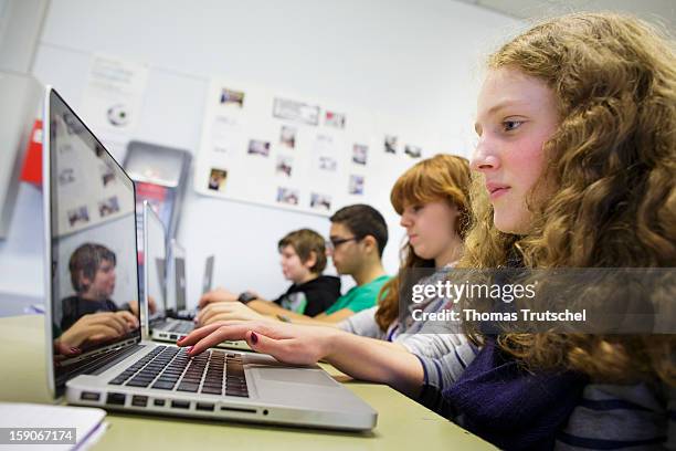 Pupils working at their lap-tops during a lesson at the Heinrich-Mann-School in the Neukoelln district of Berlin, Germany on November 07, 2012.