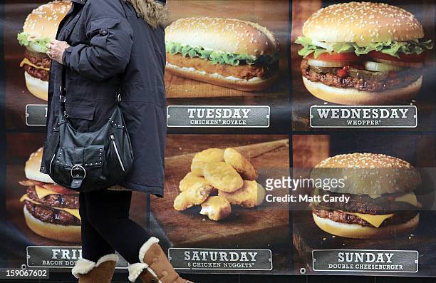 Woman passes an advertisement outside a fast food outlet on January 7, 2013 in Bristol, England. A government-backed TV advert - made by Aardman, the...