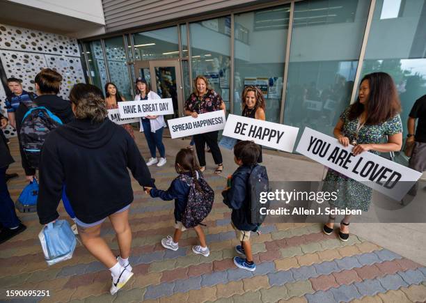 Anaheim, CA Teachers hold signs of encouragement as kids and their parents arrive for the first day of school for the Anaheim Elementary School...