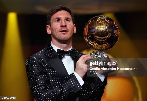 Lionel Messi of Argentina holds the trophy alloft after winning the FIFA Ballon d'Or for a fourth consecutive time during FIFA Ballon d'Or Gala 2012...