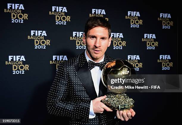 Lionel Messi of Argentina holds the trophy alloft after winning the FIFA Ballon d'Or for a fourth consecutive time during FIFA Ballon d'Or Gala 2012...