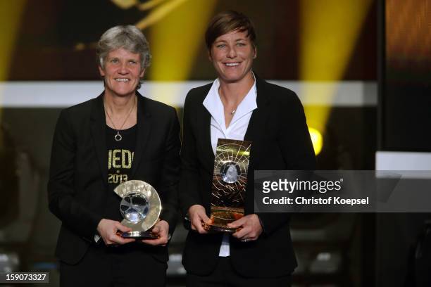 Pia Sundhage, women's coach of United States receives the FIFA World Coach of Women's Football 2012 trophy and Abby Wambach of United States receives...