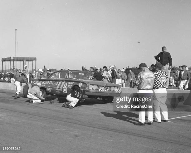 February 14, 1960: Ned Jarrett makes a pit stop during the Daytona 500 NASCAR Cup race at Daytona International Speedway. Jarrett drove his 1960 Ford...