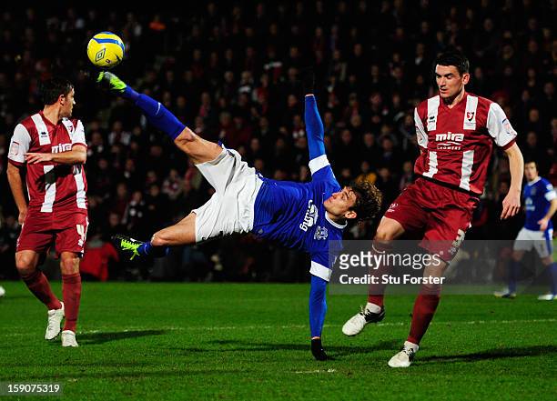 Nikica Jelavic of Everton attempts an overhead kick as Billy Jones of Cheltenham Town looks on during the FA Cup with Budweiser Third Round match...