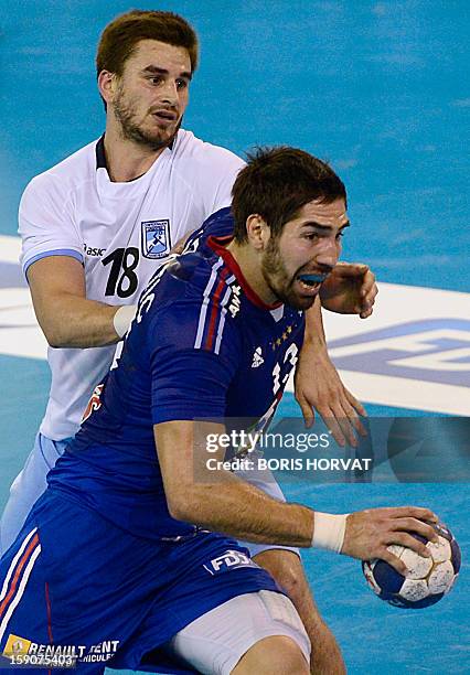 France's Nikola Karabatic vies with Argentina's Federico Vieyra during the friendly handball match France vs Argentina on January 7, 2013 in the...