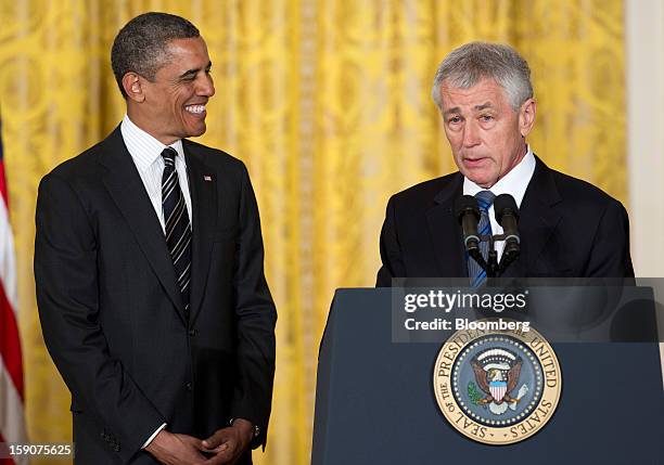 President Barack Obama, left, smiles as his nominee for Secretary of Defense Chuck Hagel, a former Republican Senator from Nebraska, speaks during an...