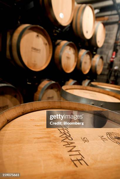 Barrels filled with wine sit in the cellar at the Ferrante Winery in Geneva, Ohio, U.S., on Friday, Jan. 4, 2013. Ice wine is a type of dessert wine...