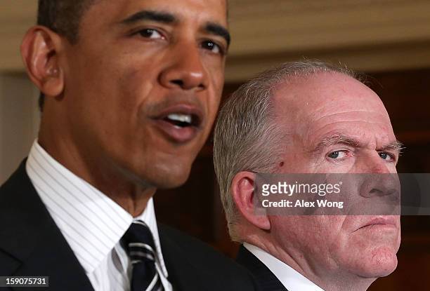President Barack Obama speaks as Deputy National Security Advisor for Homeland Security and Counterterrorism John Brennan listens while making...