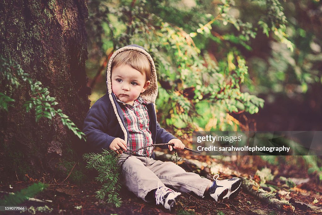 Toddler sitting in a forest