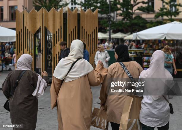 Group of tourists from the Middle East seen in Krakow's Market Square, on August 10 in Krakow, Lesser Poland Voivodeship, Poland.